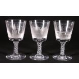 Set of three air twist wine glasses engraved with Edinburgh monuments,