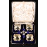 Set of four silver quatrefoil silver salts and spoons,