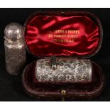 Victorian silver cylindrical scent bottle with floral engraving in fitted case and a similiar bottle