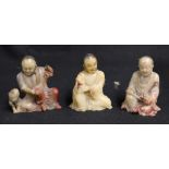 Three 19th century Chinese carved soapstone seated figures of fine quality, two holding Buddhist