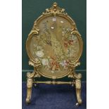 Victorian gilt gesso oval firescreen with beadwork and wool peacock tapestry on scrolling cabriole