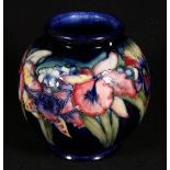 Moorcroft vase of spherical form decorated in the orchid pattern,