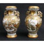 Pair of Japanese Kutani vases with lion dog handles,