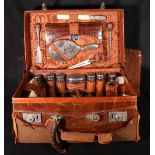 Crocodile dressing case with eighteen hammered silver and other fittings,