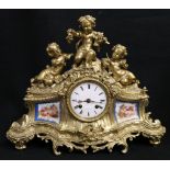 Marshall & Fils of Paris. Victorian gilded brass mantle clock surmounted with three cherubs, inset