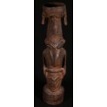 Sepik river ancester totem, the bowl surmount with bird and animal relief decoration, circular base,