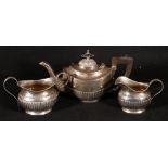 Late Victorian silver three piece batchelor's tea service, maker J G, of oval demi-fluted form,