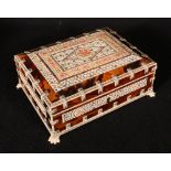 Indian ivory bone and tortoiseshell casket on four paw feet, pierced work panels to the top and