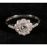 Edwardian 18ct gold and platinum diamond flowerhead ring, the central round brillant cut 4mm dia.