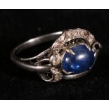 Ring with cabochon blue and small white sapphires in white gold '14kt'