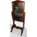 Regency mahogany cheval mirror with arched pediment, on scroll legs on brass castors,