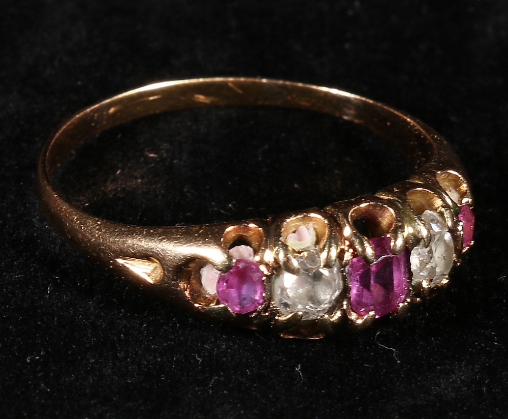Yellow metal ring set three rounded mixed cut pink sapphires and two old cut diamonds