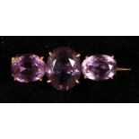 Yellow metal bar brooch set three oval cut amethysts