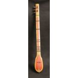 Iranian musical instrument of red lacquered wood, possibly a tanbur,