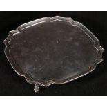 20th century Silver tray of square form raised on four claw supports approx 650g, 25.