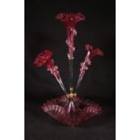 Victorian cranberry glass epergne the twin branches with baskets, central frill vase on circular