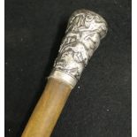 19th century rhinoceros hide walking cane, the pommel of silver with relief decoration of lions,