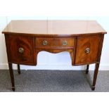Georgian style bow front desk raised on square tapering supports