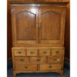 19th century oak cabinet on stand with dentil cornice above a pair of panel doors flanked by