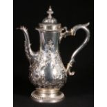 Silver heavily embossed and engraved hot water jug. London marks rubbed. 28oz, 27cm high CONDITION