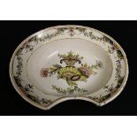 19th century French faience bleeding bowl decorated with cornucopia and vase of flowers,