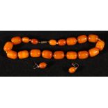 Butterscotch amber bead necklace with eighteen graduated beads, largest 20cm smallest 15cm,