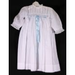 Child's cotton coat with lace collar edge, two under dresses,