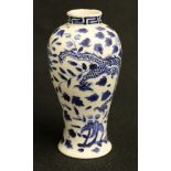 A small 19th century Chinese blue and white high shouldered vase decorated with a dragon amongst