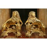 Pair of early 19th century brass lion chenets, the lions raised up on crested shields,