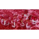 Group of seven pieces of Mary Gregory style cranberry glass including a pair of stem vases,