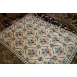 Black ground woolwork rug with floral decoration 185cm x 130cm,