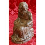 18th century Continental carved walnut figure of a seated gentleman beside an hour glass,