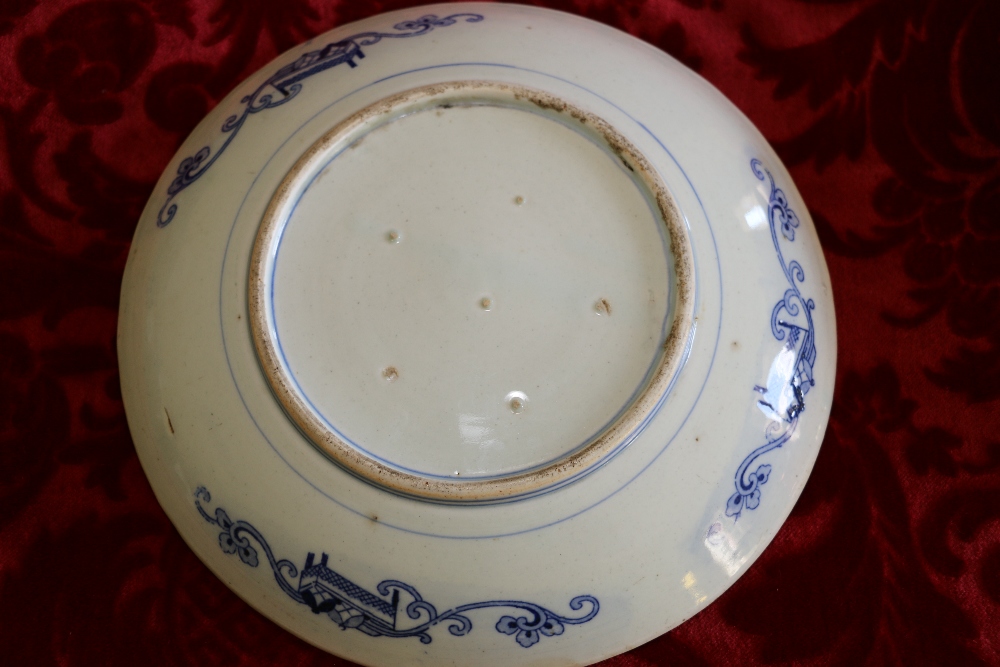 Pair of transfer printed blue and white dishes depicting figures in a garden. - Image 2 of 2