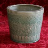 20th century celadon jardiniere with scrolling flower decoration.