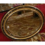 19th century glass mounted ebonised oval mirror, 75cm x 60cm CONDITION REPORT: Majority of the