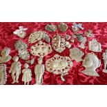 Group of silver coloured metal ex voto, mainly anatomical,