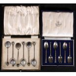 Set of six enamelled silver coffee spoons and another set, with ribbed bands, both cased.