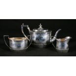 Victorian silver three-piece tea set of demi-fluted oval form with bright-cut ribbon border,