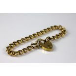 A 9ct yellow gold curb link bracelet wit