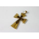 A yellow metal cross pendant, the yellow