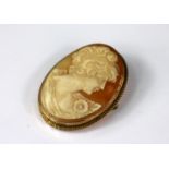 A carved shell cameo brooch in 9ct yello