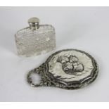 A silver backed hand mirror embossed wit