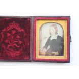 A Victorian Daguerreotype depicting a seated lady within gilt slip and fitted case, image size 4cm