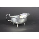 A silver sauce boat Adie Brothers Ltd, Birmingham 1927, of low form, raised on three stepped hoof