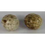 A pair of carved sectional bone eggs, 14cm