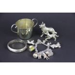 A silver charm bracelet with padlock clasp and suspending various charms including; a pear, a bear,