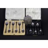 A cased set of silver teaspoons, Walker and Hall, Sheffield 1935, each with pierced terminal, along