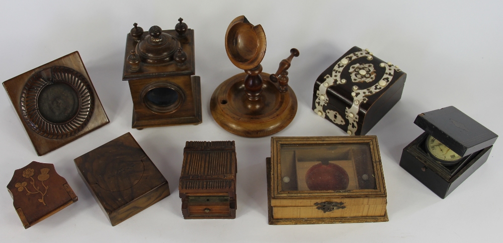 A collection of 19th century treen pocket watch stands and cases, comprising a Black Forest stand