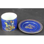 A Carlton Ware powder blue decorated sugar bowl and stand decorated with Chinoiserie views,