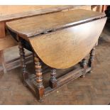 An early 18th century oak gate leg table, on turned and block legs,